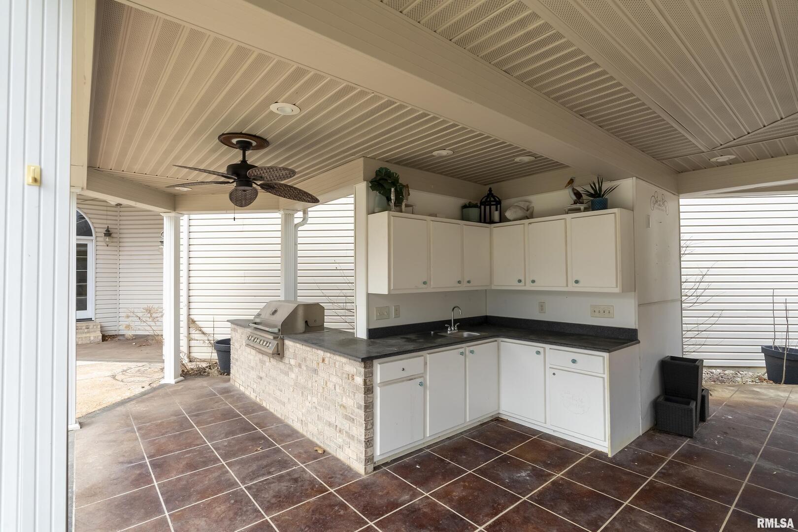 3115 West Striegel Road Carbondale, IL 62901 - Photo 50 of 54 a kitchen with granite countertop a sink a counter space and cabinets