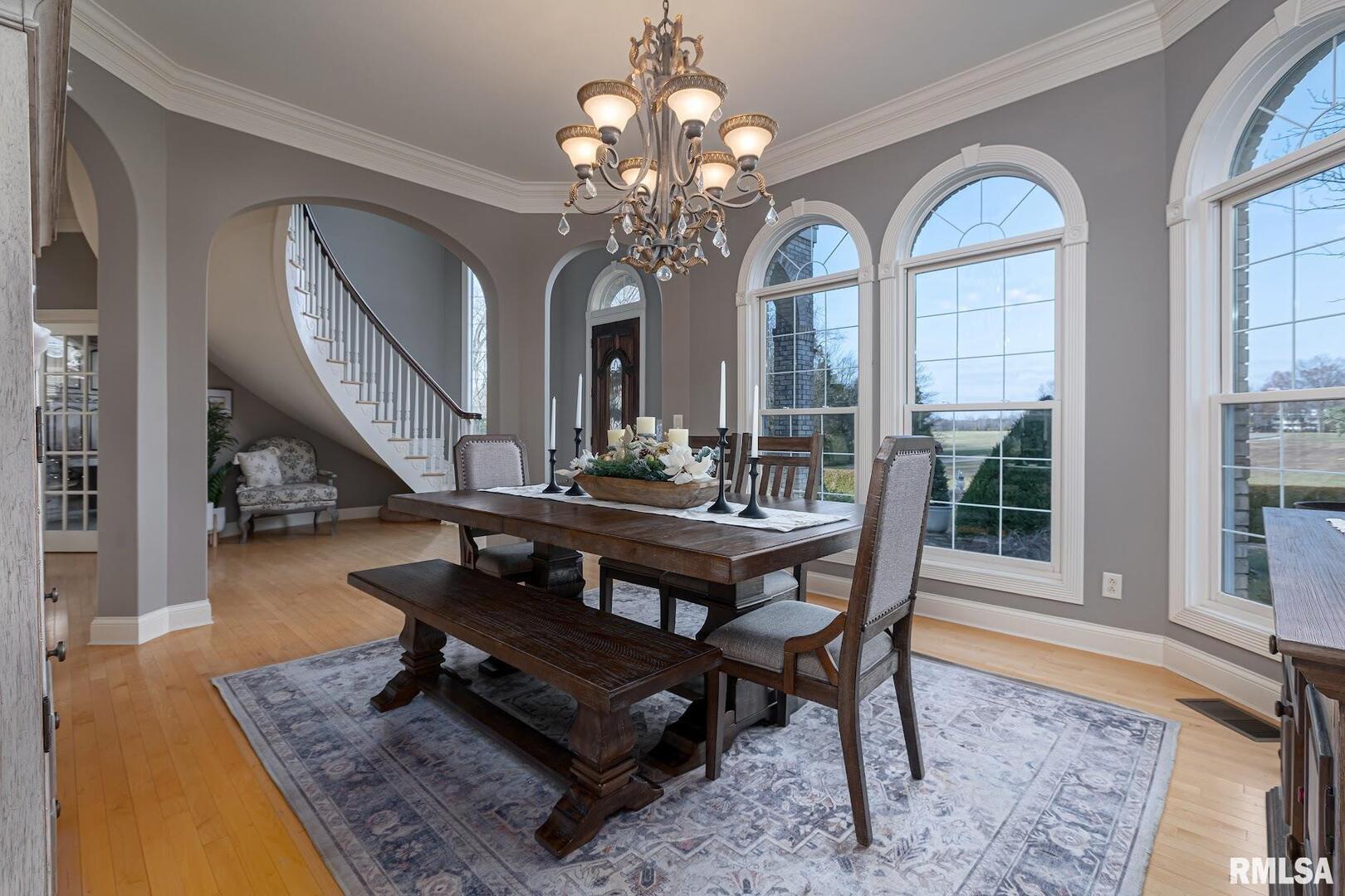 3115 West Striegel Road Carbondale, IL 62901 - Photo 6 of 54 a living room with a table chairs and a chandelier