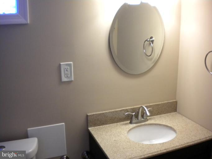 812 Wicklow Road Baltimore, MD 21229 - Photo 20 of 30 a bathroom with a granite countertop sink and a mirror