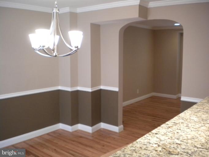 812 Wicklow Road Baltimore, MD 21229 - Photo 26 of 30 a view of a hallway with wooden floor and chandelier