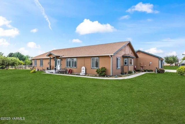 a front view of house with yard and green space