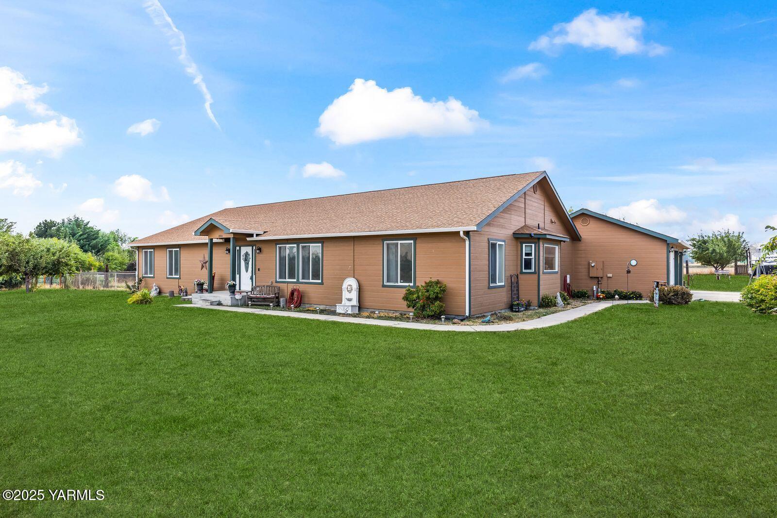 a front view of house with yard and green space
