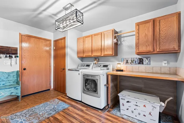 a view of kitchen with stainless steel appliances granite countertop a stove a sink and a microwave