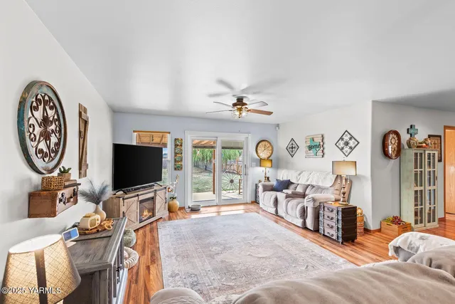a bedroom with furniture a flat screen tv and a window