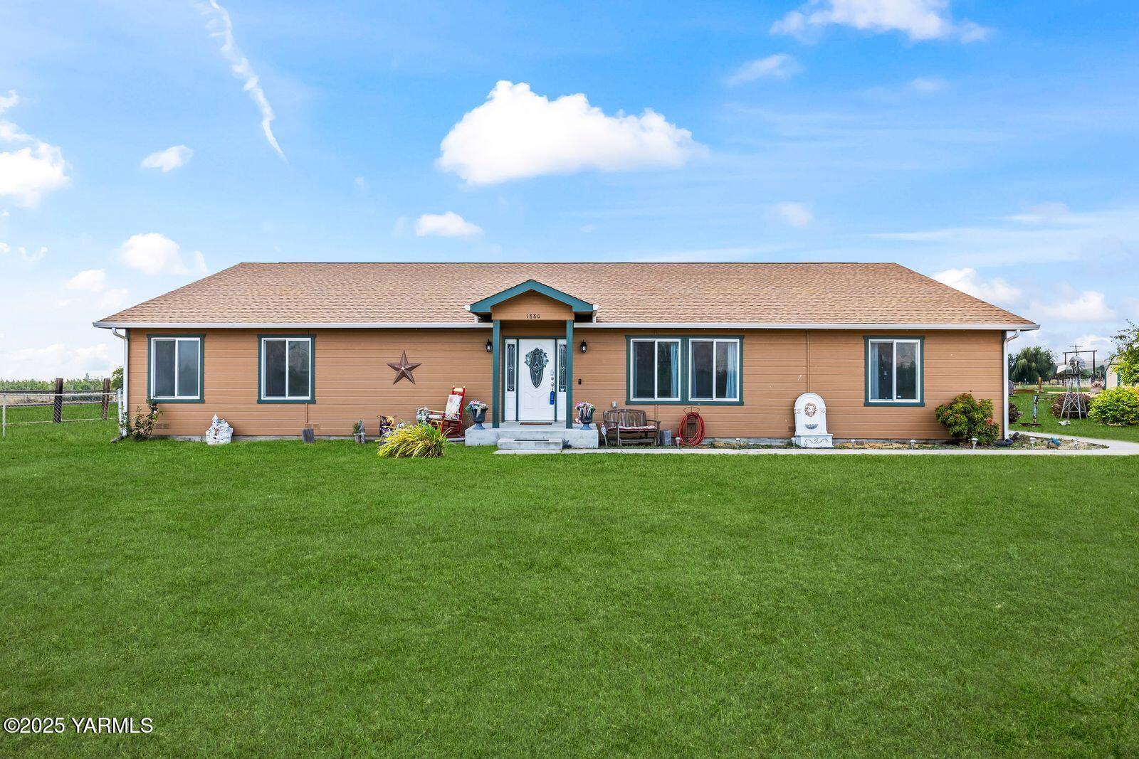 1880 Dilley Road Tieton, WA 98947 - Photo 2 of 45 a front view of a house with a garden