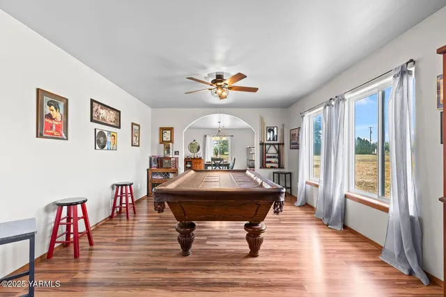 a living room with furniture table and a large window