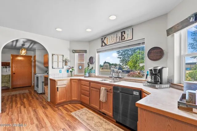 a kitchen with a sink cabinets and window
