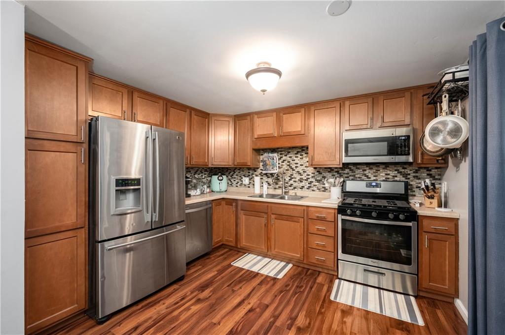 110 Avon Drive Butler, PA 16001 - Photo 11 of 35 a kitchen with granite countertop stainless steel appliances a refrigerator a stove top oven and cabinets