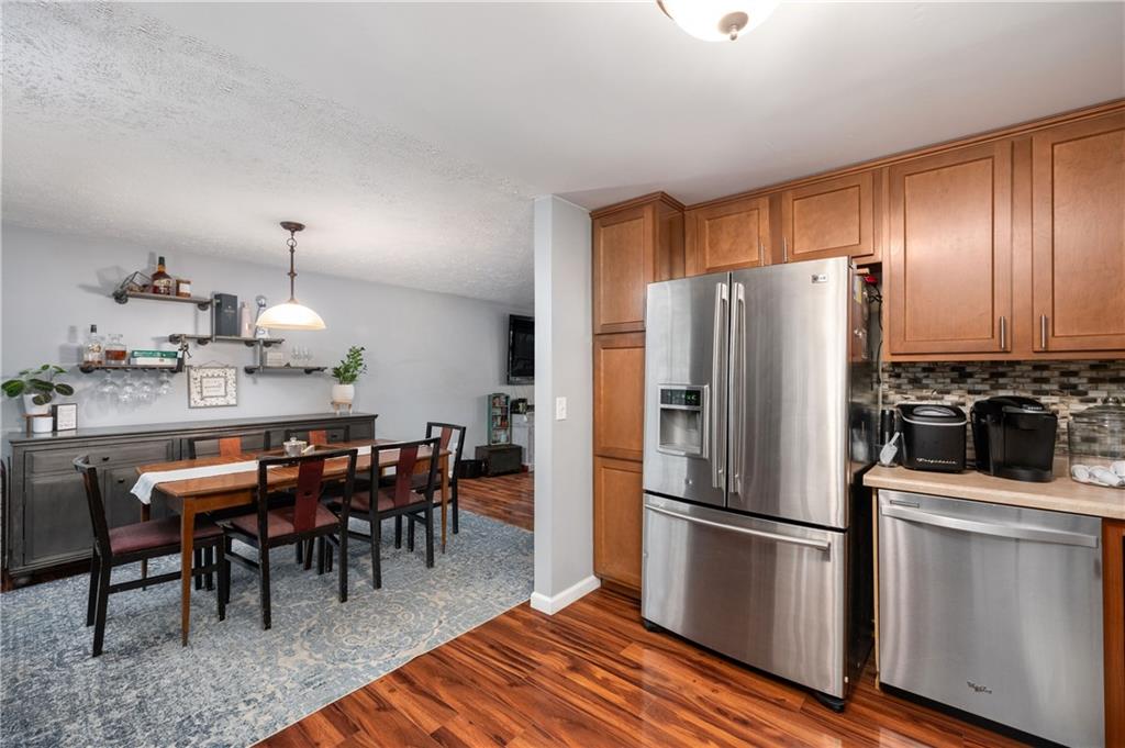 110 Avon Drive Butler, PA 16001 - Photo 15 of 35 a kitchen with stainless steel appliances a refrigerator a stove a dining table and chairs