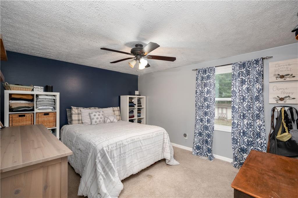 110 Avon Drive Butler, PA 16001 - Photo 18 of 35 a bedroom with a bed and a chandelier