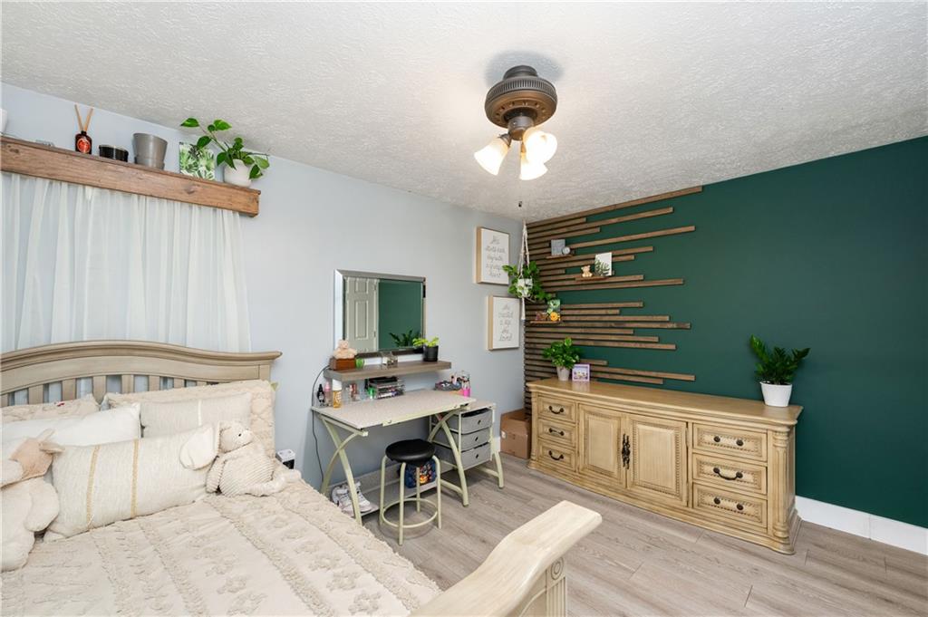 110 Avon Drive Butler, PA 16001 - Photo 22 of 35 a room with furniture a chandelier and a flat screen tv