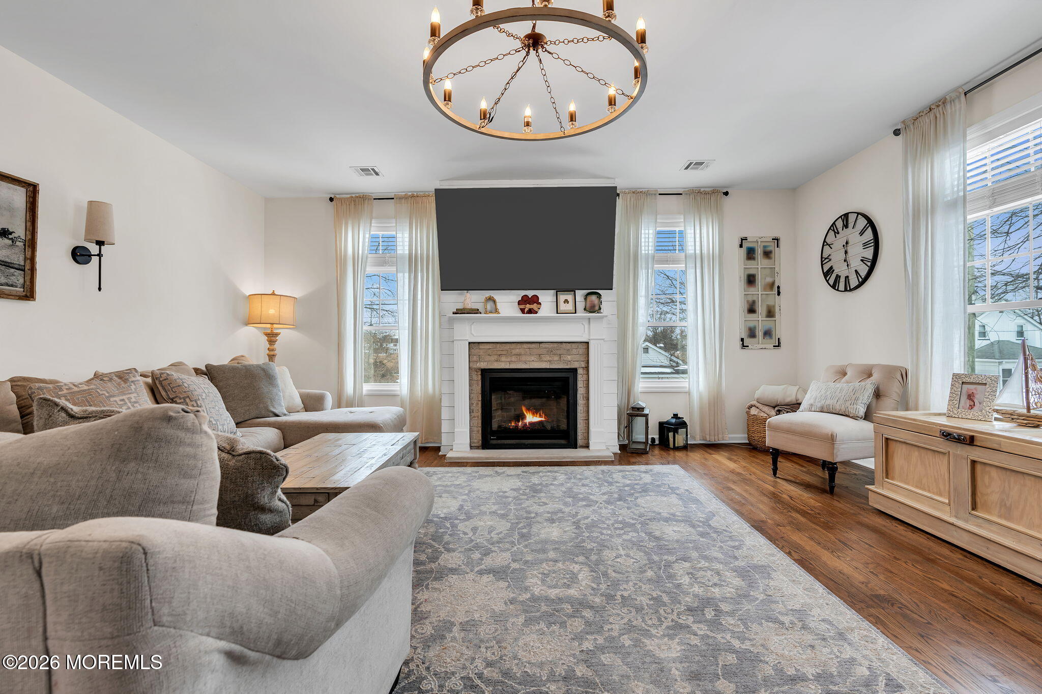 1202 High Avenue Union Beach, NJ 07735 - Photo 11 of 44 a living room with furniture a clock and a fireplace
