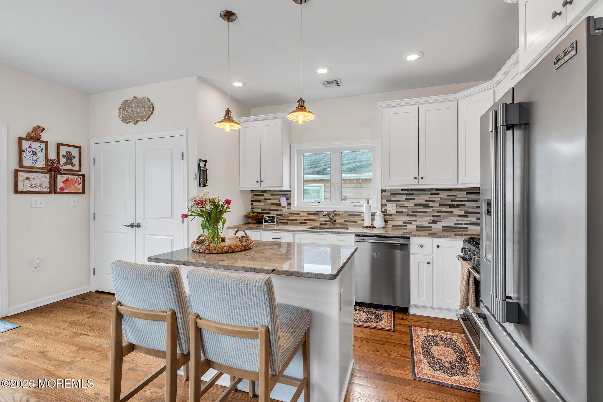 1202 High Avenue Union Beach, NJ 07735 - Photo 18 of 44 a kitchen with a dining table chairs stainless steel appliances and cabinets