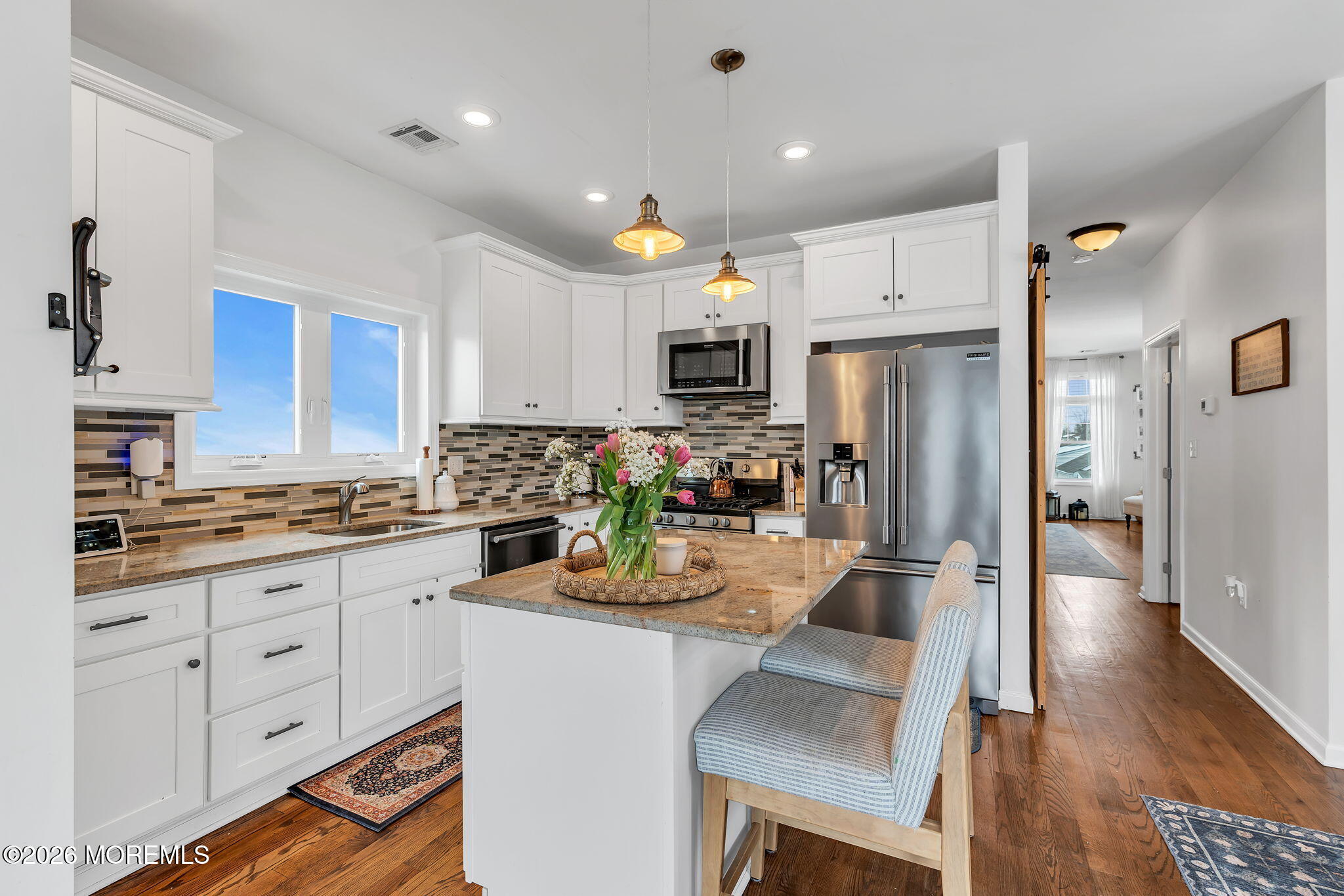1202 High Avenue Union Beach, NJ 07735 - Photo 19 of 44 a kitchen with white cabinets and stainless steel appliances