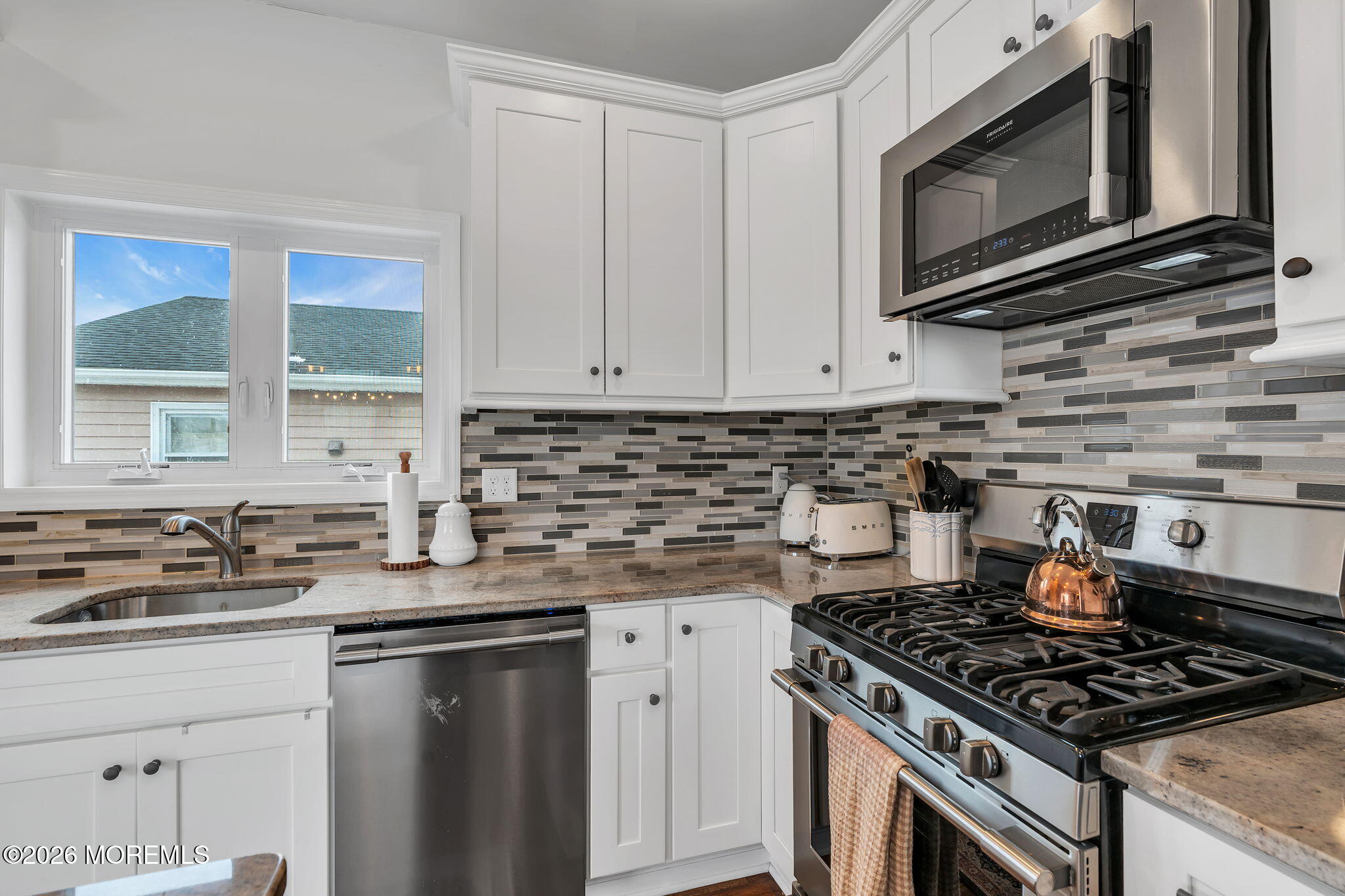 1202 High Avenue Union Beach, NJ 07735 - Photo 22 of 44 a kitchen with granite countertop a sink stove and microwave