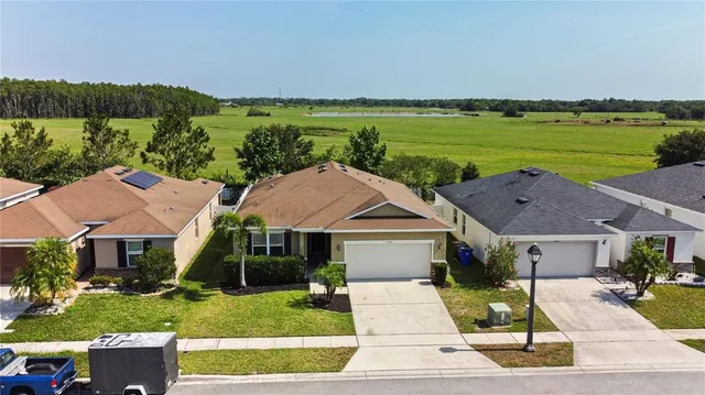 a aerial view of a house with a garden and lake view