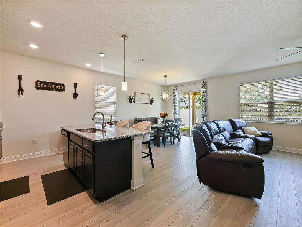 4553 Baler Trails Drive St. Cloud, FL 34772 - Photo 13 of 32 a living room with furniture a large window and wooden floor