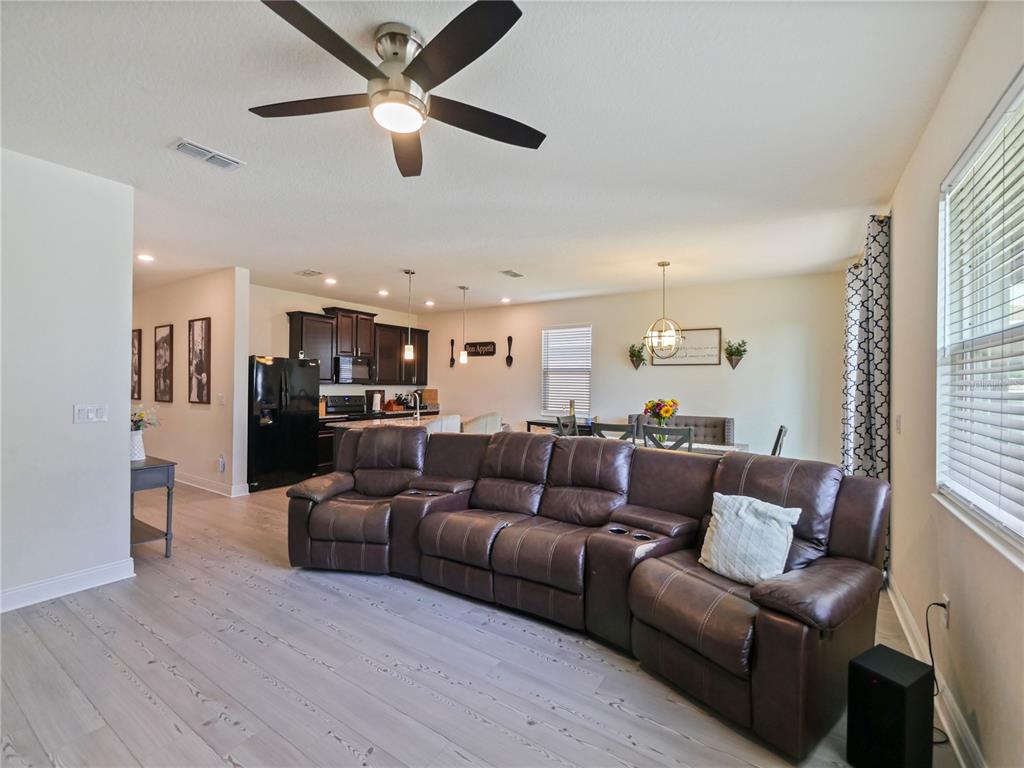 4553 Baler Trails Drive St. Cloud, FL 34772 - Photo 16 of 32 a living room with furniture kitchen area and a window