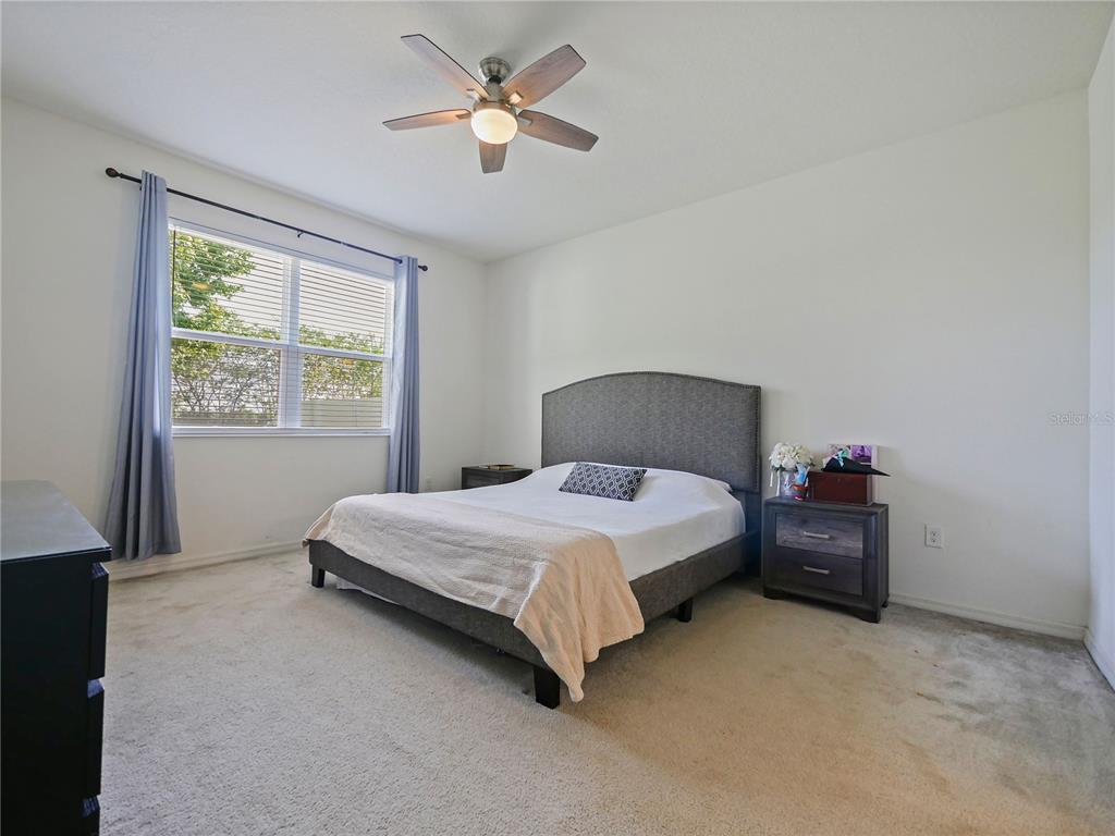 4553 Baler Trails Drive St. Cloud, FL 34772 - Photo 19 of 32 a bedroom with a bed and a window