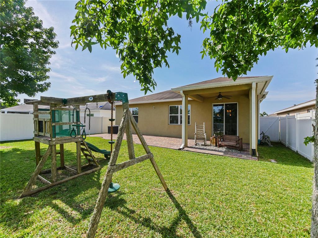 4553 Baler Trails Drive St. Cloud, FL 34772 - Photo 25 of 32 a view of a house with backyard porch and sitting area