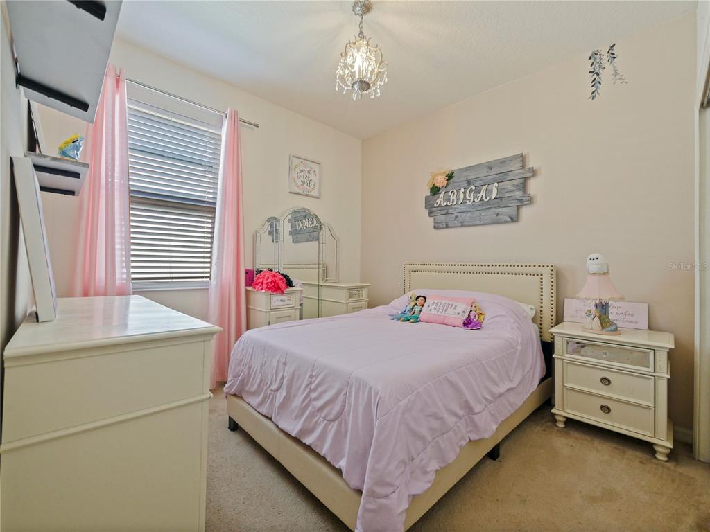 4553 Baler Trails Drive St. Cloud, FL 34772 - Photo 8 of 32 a bedroom with a bed and a dresser