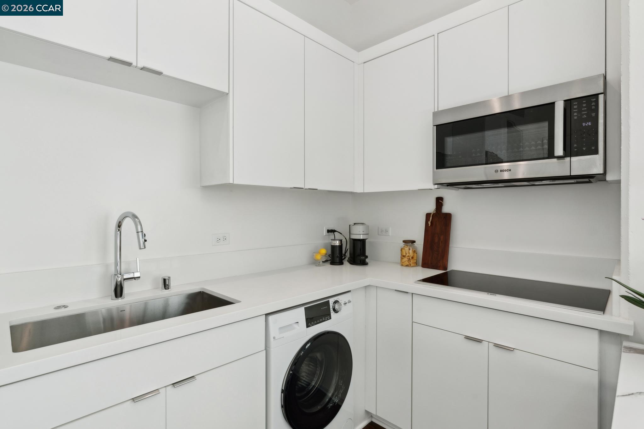 210 Lafayette Circle, Unit 101 Lafayette, CA 94549 - Photo 20 of 41 a kitchen with stainless steel appliances a sink a microwave and cabinets