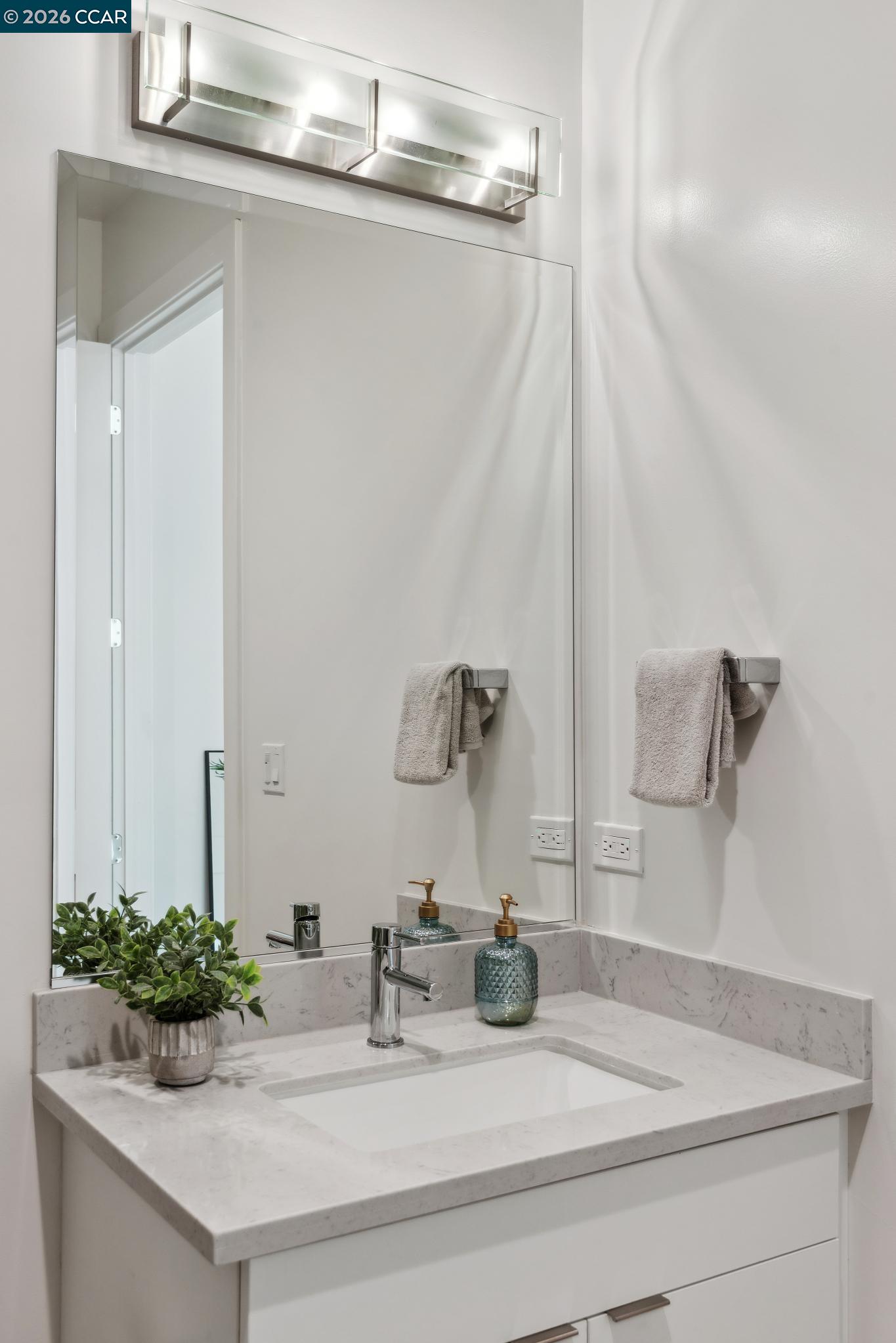 210 Lafayette Circle, Unit 101 Lafayette, CA 94549 - Photo 32 of 41 a bathroom with a sink and a mirror