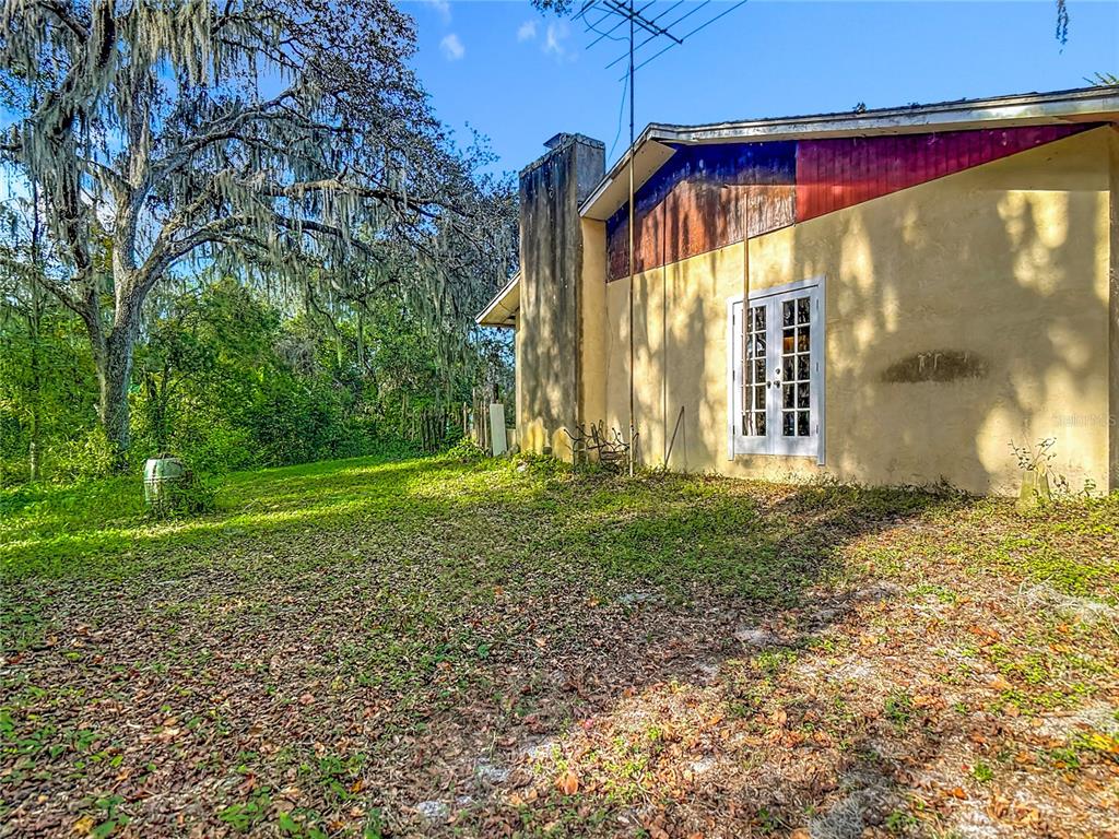 22380 Powell Road Brooksville, FL 34602 - Photo 2 of 45 a view of a house with backyard and porch