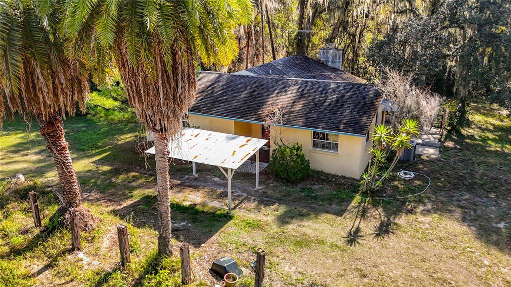 22380 Powell Road Brooksville, FL 34602 - Photo 41 of 45 a view of backyard with a table and chairs under an umbrella