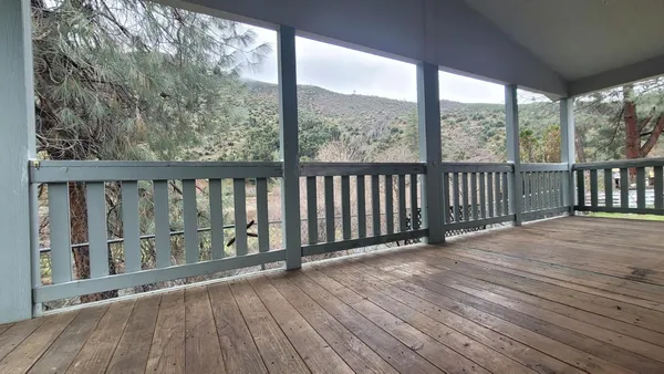a view of a balcony with wooden floor