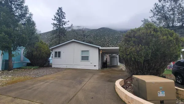 a view of kitchen with sink microwave and stove top oven