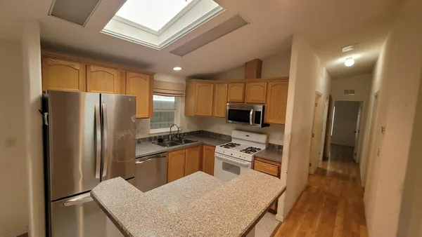 a kitchen with a refrigerator stove and sink