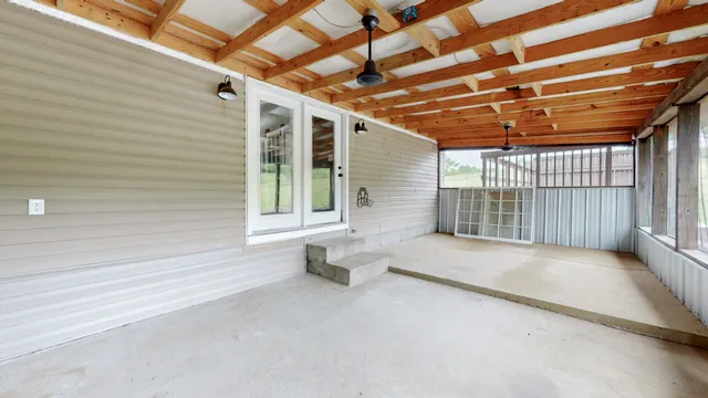a view of porch with a table and chairs