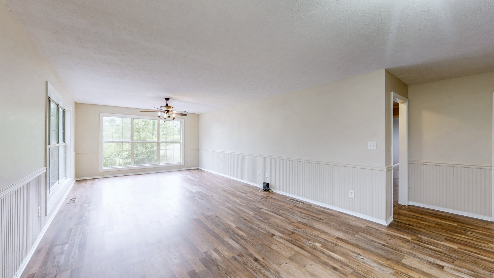 75 Vantrease Road Brush Creek, TN 38547 - Photo 4 of 34 an empty room with wooden floor and windows