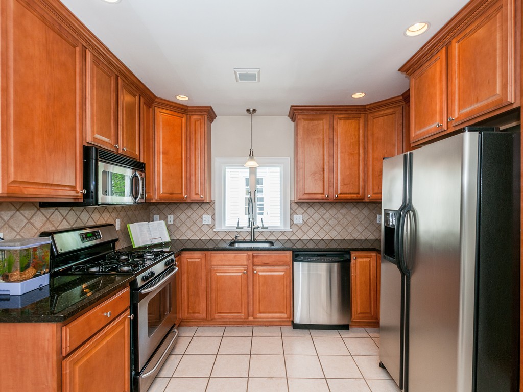 15 Banks Street, Unit 4 Waltham, MA 02451 - Photo 11 of 19 a kitchen with stainless steel appliances granite countertop a stove a sink dishwasher and a refrigerator