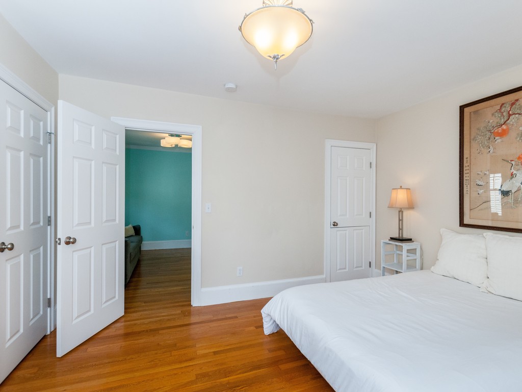 15 Banks Street, Unit 4 Waltham, MA 02451 - Photo 12 of 19 a bedroom with a bed and wooden floor