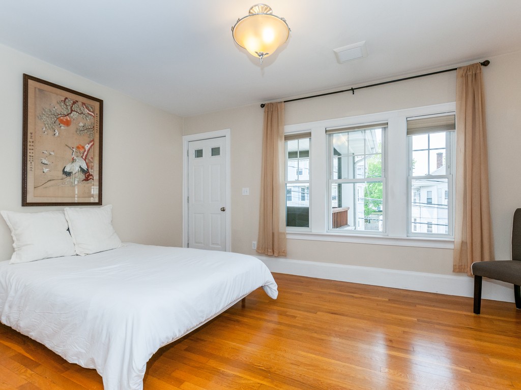 15 Banks Street, Unit 4 Waltham, MA 02451 - Photo 13 of 19 a bedroom with a bed and a large window