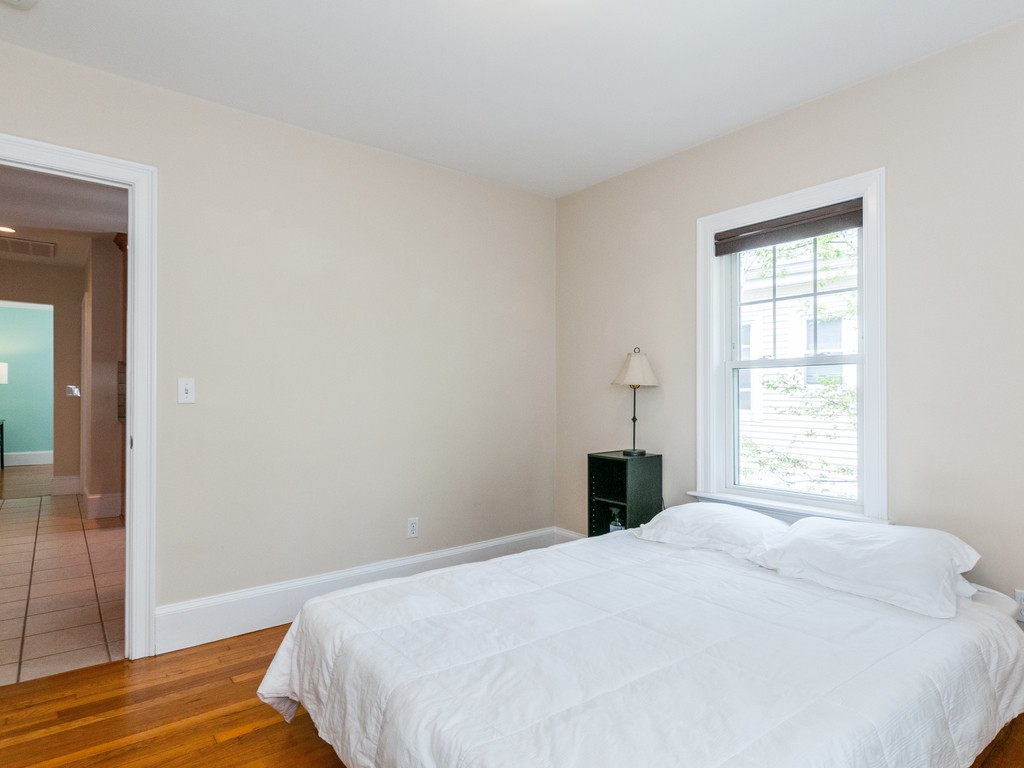 15 Banks Street, Unit 4 Waltham, MA 02451 - Photo 14 of 19 a bedroom with a bed and a window