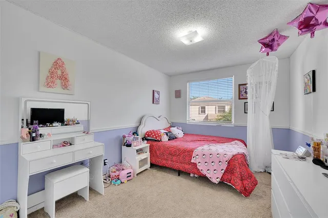 a bedroom with a bed and a tv