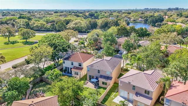 an aerial view of multiple houses with yard