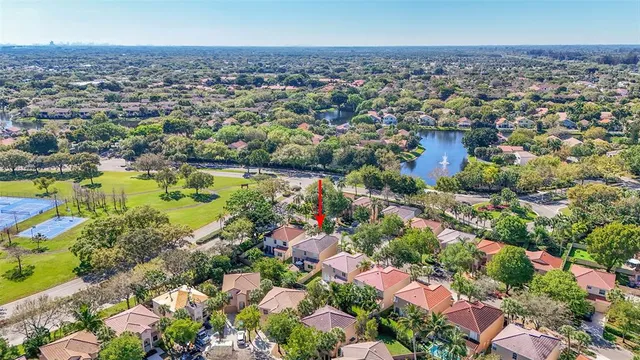 an aerial view of residential houses with outdoor space and swimming pool