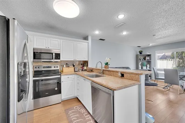 a kitchen that has a sink and a stove in it