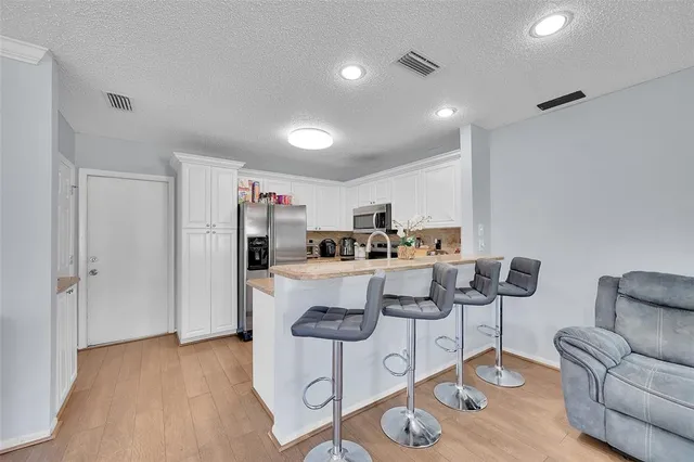 a living room with furniture and a kitchen view