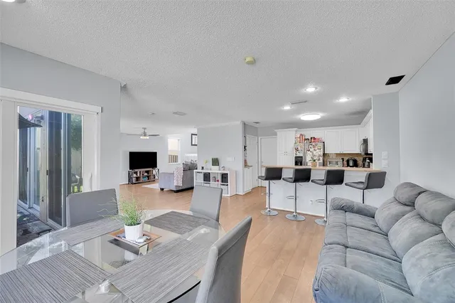 a living room with furniture and a view of kitchen