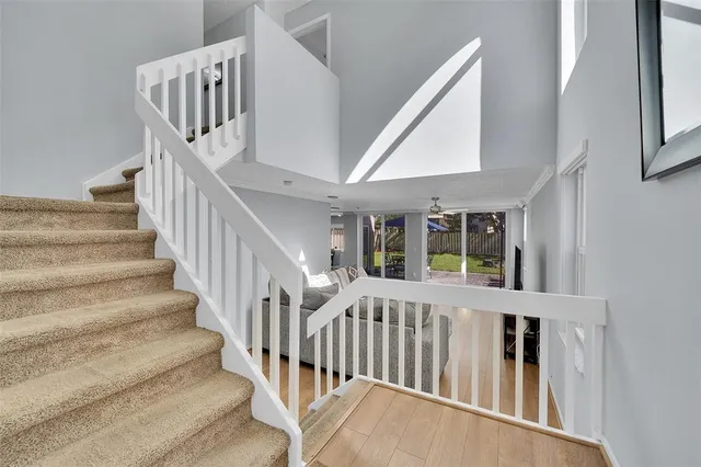 a view of staircase with lots of windows and white walls