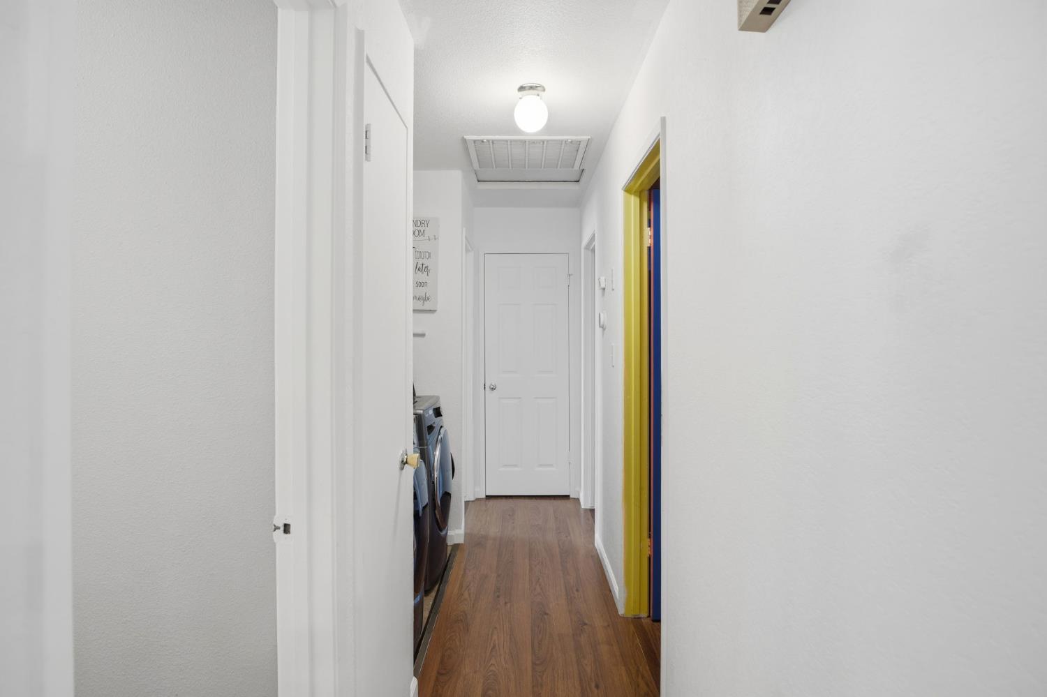 1308 Basil Court Newman, CA 95360 - Photo 12 of 20 a view of a hallway with wooden floor and closet