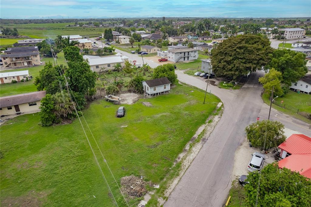 601 Southwest 6th Street Belle Glade, FL 33430 - Photo 7 of 7 an aerial view of residential houses with outdoor space and trees
