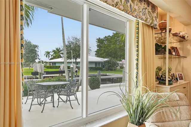 a view of a house with a yard and a pond