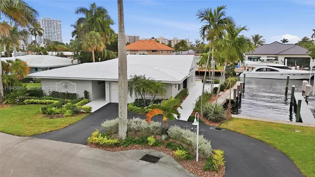 a living room with furniture and a large window with garden view