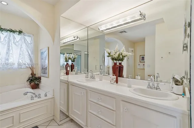 a view of a house with a yard and palm trees